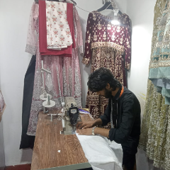 Professional ladies tailor stitching a custom dress with precision